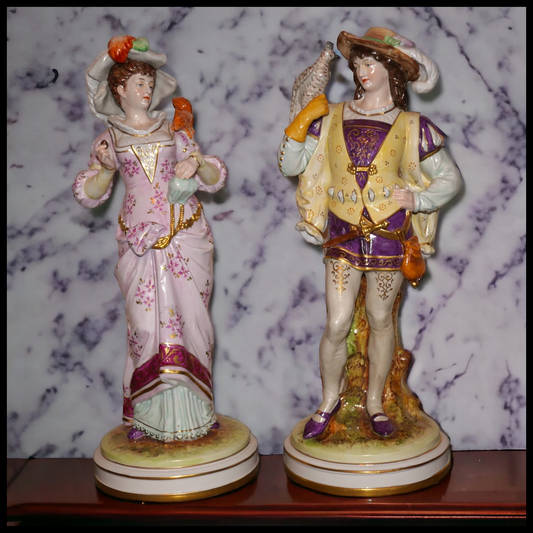 Set of 2 Circa 1930 German Kister Porcelain Victorian 19th Century Style Male Falconer and Woman Feeding Squirrel Figurines