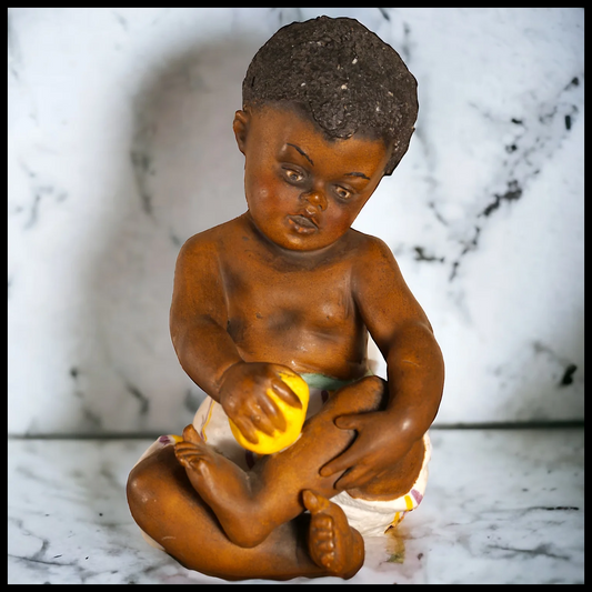 Circa 1910 German Gebruder Heubach Bisque Black Piano Baby with Lemon Figurine