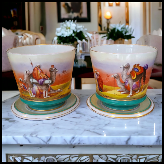 Pair of Circa 1850 French Napoleon III Porcelain de Paris Hand Painted Arabic Bedouins/Camels in Desert Scene Motif Cachepots with Stands